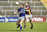 6 July 2014; Kevin Meaney, Laois, in action against Paddy Byrne, Wexford.  GAA Football All Ireland Senior Championship, Round 2A, Wexford v Laois, Wexford Park, Wexford. Picture credit: Barry Cregg / SPORTSFILE