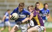 6 July 2014; Ross Munnelly, Laois, in action against Michael Furlong, Wexford.  GAA Football All Ireland Senior Championship, Round 2A, Wexford v Laois, Wexford Park, Wexford. Picture credit: Barry Cregg / SPORTSFILE