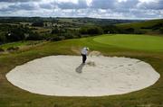 24 July 2006; Two time Major winner John Daly chips out of a bunker at the Par 5, 601yard 7th green, the signature hole, during the opening of the Blarney Golf Resort, Blarney, Co. Cork. The 50 million euro complex on a magnificent 164 acre site, has as it's centrepiece, a John Daly designed championship course and also comprises a 62 bedroom Ramada Hotel, 56 luxury self catering suites and the Sentosa Spa. This is the first course in Europe to be designed by John Daly. Picture credit: Brendan Moran / SPORTSFILE