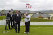 24 July 2006; Two time Major winner John Daly, in the company of the Minister for Arts, Sport and Tourism, John O'Donoghue, TD, puts the flag in the 18th hole at the opening of the Blarney Golf Resort, Blarney, Co. Cork. The 50 million euro complex on a magnificent 164 acre site, has as it's centrepiece, a John Daly designed championship course and also comprises a 62 bedroom Ramada Hotel, 56 luxury self catering suites and the Sentosa Spa. This is the first course in Europe to be designed by John Daly. Picture credit: Brendan Moran / SPORTSFILE
