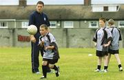 27 July 2006; The Vhi Cul Camps, the official GAA summer camps, got off to a flying start all around the country at the start of July and are now in full swing with up to 75,000 children expected to attend the camps nationwide between July 3rd and 25th August. At the Parnells GAA camp in Coolock, Dublin, is Dublin footballer and Vhi Cul Camp ambassador Conal Keaney with children from the Coolock / Artane area. Chanel School, Coolock, Dublin. Picture credit; Brendan Moran / SPORTSFILE