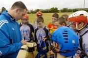 28 July 2006; The Vhi Cul Camps, the official GAA summer camps, got off to a flying start all around the country at the start of July and are now in full swing with up to 75,000 children expected to attend the camps nationwide between July 3rd and 25th August. Pictured at the camp in Bagenalstown, Co. Carlow, Tipperary hurler and Vhi Cul Camp ambassador Eoin Kelly who was coaching and the kids and then signed autographs. Bagenalstown, Co. Carlow. Picture credit; Matt Browne / SPORTSFILE