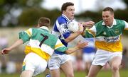 30 July 2006; Ian Fitzgerald, Laois, in action against Karol Slattery, left, and Ger Rafferty, Offaly. Bank of Ireland All-Ireland Senior Football Championship Qualifier, Round 4, Laois v Offaly, O'Moore Park, Portlaoise, Co. Laois. Picture credit; Brian Lawless / SPORTSFILE