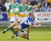 30 July 2006; Ross Munnelly, Laois, in action against Karol Slattery, Offaly. Bank of Ireland All-Ireland Senior Football Championship Qualifier, Round 4, Laois v Offaly, O'Moore Park, Portlaoise, Co. Laois. Picture credit; Brian Lawless / SPORTSFILE