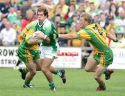 30 July 2006; Ryan Keenan, Fermanagh, in action against Neil McGee and Thomas Donaghue, Donegal. Bank of Ireland All-Ireland Senior Football Championship Qualifier, Round 4, Fermanagh v Donegal, Brewster Park, Enniskillen, Co. Fermanagh. Picture credit; Oliver McVeigh / SPORTSFILE