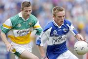 30 July 2006; Ross Munnelly, Laois, in action against Karol Slattery, Offaly. Bank of Ireland All-Ireland Senior Football Championship Qualifier, Round 4, Laois v Offaly, O'Moore Park, Portlaoise, Co. Laois. Picture credit; Damien Eagers / SPORTSFILE