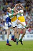 30 July 2006; Padraig Clancy, Laois, in action against Neville Coughlan, left, and Mark Daly, Offaly. Bank of Ireland All-Ireland Senior Football Championship Qualifier, Round 4, Laois v Offaly, O'Moore Park, Portlaoise, Co. Laois. Picture credit; Brian Lawless / SPORTSFILE