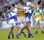 30 July 2006; Ciaran McManus, Offaly, in action against Tom Kelly, left, and Chris Conway, Laois. Bank of Ireland All-Ireland Senior Football Championship Qualifier, Round 4, Laois v Offaly, O'Moore Park, Portlaoise, Co. Laois. Picture credit; Brian Lawless / SPORTSFILE