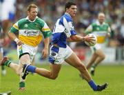 30 July 2006; Brendan Quigley, Laois, in action against Neville Coughlan, Offaly. Bank of Ireland All-Ireland Senior Football Championship Qualifier, Round 4, Laois v Offaly, O'Moore Park, Portlaoise, Co. Laois. Picture credit; Brian Lawless / SPORTSFILE