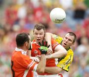 5 August 2006; Ronan Clarke, Armagh, holds off the challange from Michael McCarthy, Kerry, to pass to his team-mate Steven McDonell, foreground, to score his side's first goal. Bank of Ireland All-Ireland Senior Football Championship Quarter-Final, Armagh v Kerry, Croke Park, Dublin. Picture credit; David Maher / SPORTSFILE