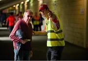 6 July 2014; Pairc Ui Chaoimh steward Colm Vaughan assists a supporter before the game. Munster GAA Football Senior Championship Final, Cork v Kerry, Páirc Ui Chaoimh, Cork. Picture credit: Diarmuid Greene / SPORTSFILE