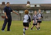 27 July 2006; The Vhi Cul Camps, the official GAA summer camps, got off to a flying start all around the country at the start of July and are now in full swing with up to 75,000 children expected to attend the camps nationwide between July 3rd and 25th August. Pictured at the Parnells GAA camp in Coolock, Dublin is Dublin footballer and Vhi Cul Camp ambassador Conal Keaney with children from the Coolock / Artane area. Chanel School, Coolock, Dublin. Picture credit; Brendan Moran / SPORTSFILE