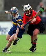 7 August 1999; Deirdre Hughes of Tipperary is tackled by Donna Greeran of Down during the All Ireland senior camogie championship semi-final match between Down and Tipperary at Parnell Park in Dublin. Photo by Ray McManus/Sportsfile