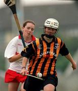 7 August 1999; Lizzie Lyng of kilkenny in action against Paula O'Connor of Cork during the Bórd na Gaeilge All Ireland Senior Camogie Championship Semi-Final match between Cork and Kilkenny at Parnell Park in Dublin. Photo by Ray McManus/Sportsfile