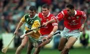 8 August 1999; Paudie Mulhare of Offaly is tackled by Diarmaid O'Sullivan, centre, and Sean Og O'hAilpin of Cork during the Guinness All-Ireland Hurling Senior Championship Semi-Final match between Cork and Offaly at Croke Park in Dublin. Photo by Ray McManus/Sportsfile