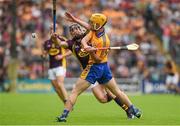 12 July 2014; Colm Galvin, Clare, clears under pressure from Liam Og McGovern, Wexford. GAA Hurling All-Ireland Senior Championship Round 1 Replay, Clare v Wexford, Wexford Park, Wexford. Picture credit: Ray McManus / SPORTSFILE