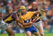 12 July 2014; Colm Galvin, Clare, in action against Diarmuid O'Keeffe, right, and Keith Rossiter, Wexford. GAA Hurling All-Ireland Senior Championship Round 1 Replay, Clare v Wexford, Wexford Park, Wexford. Picture credit: Ray McManus / SPORTSFILE