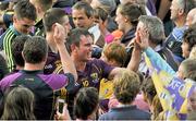 12 July 2014; Paul Morris, Wexford, celebrates with supporters after the game. GAA Hurling All-Ireland Senior Championship Round 1 Replay, Clare v Wexford, Wexford Park, Wexford. Picture credit: Dáire Brennan / SPORTSFILE