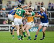 12 July 2014; Noel McGrath, left, Tipperary, and team-mate Patrick Maher, right, in action against Dan Currams, 14, and Kevin Brady, Offaly. GAA Hurling All-Ireland Senior Championship Round 2, Tipperary v Offaly. O'Moore Park, Portlaoise, Co. Laois. Picture credit: Piaras Ó Mídheach / SPORTSFILE