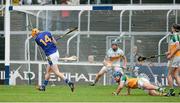 12 July 2014; Séamus Callanan, Tipperary, is hit by the hurley of Cathal Parlon, right, Offaly, as he scores his side's fifth goal. GAA Hurling All-Ireland Senior Championship Round 2, Tipperary v Offaly. O'Moore Park, Portlaoise, Co. Laois. Picture credit: Piaras Ó Mídheach / SPORTSFILE