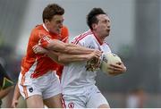 13 July 2014; Colm Cavanagh, Tyrone, in action against Charlie Vernon, Armagh. GAA Football All-Ireland Senior Championship Round 2B, Tyrone v Armagh, Healy Park, Omagh, Co. Tyrone. Picture credit: Ramsey Cardy / SPORTSFILE