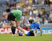 13 August 2006; Clare referee Ger Hoey checks on the welfare of Tipperary's  Thomas McGrath near the end of the game. All-Ireland Minor Hurling Championship, Semi-Final, Kilkenny v Tipperary, Croke Park, Dublin. Picture credit; Ray McManus / SPORTSFILE