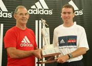 19 August 2006; Charlie Cruise, President of Civil Service A.C., presents the winner Cian McLoughlin, Clonliffe Harriers A.C., with the Frank Duffy Memorial Trophy. Frank Duffy 10 mile race. Phoenix Park, Dublin. Picture credit: Tomas Greally / SPORTSFILE