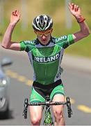 16 July 2014; Eddie Dunbar, Team Ireland, celebrates as he crosses the finishline to take victory on Stage 2 of the 2014 International Junior Tour of Ireland, Ennis - Ennis, Co. Clare. Picture credit: Stephen McMahon / SPORTSFILE