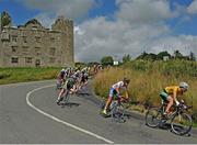 16 July 2014; Race leader Michael O'Loughlin, Team Ireland, leads a chasing group as the race passes the ruins of Leamaneh Castle during Stage 2 of the 2014 International Junior Tour of Ireland, Ennis - Ennis, Co. Clare. Picture credit: Stephen McMahon / SPORTSFILE