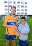 16 July 2014; Aaron Cunningham, Clare, is presented with TG4/Bord Gáis Energy Man of the Match Award by Clare supporter Tomás Carolan, aged 11, from Quin, Co. Clare. Bord Gais Energy Munster GAA Hurling Under 21 Championship Semi-Final, Clare v Tipperary, Cusack Park, Ennis, Co. Clare Picture credit: Diarmuid Greene / SPORTSFILE
