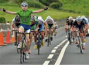 17 July 2014; Matthew Teggart, Nicolas Roche Performance Team, celebrates as he approaches the finish line to take victory on Stage 3 of the 2014 International Junior Tour of Ireland, Ennis - Ennistimon, Co. Clare. Picture credit: Stephen McMahon / SPORTSFILE