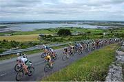 17 July 2014; A general view of the action as the peloton aproaches Carron during Stage 3 of the 2014 International Junior Tour of Ireland, Ennis - Ennistimon, Co. Clare. Picture credit: Stephen McMahon / SPORTSFILE