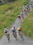 17 July 2014; Race leader Eddie Dunbar, Team Ireland, in yellow, leads the peloton on the ascent of the Category 1 climb of Castle Hill during Stage 3 of the 2014 International Junior Tour of Ireland, Ennis - Ennistimon, Co. Clare. Picture credit: Stephen McMahon / SPORTSFILE
