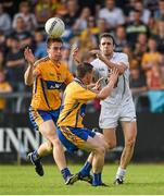 19 July 2014; Cathal McNally, Kildare, in action against Jamie Malone, left, and Martin McMahon, Clare. GAA Football All Ireland Senior Championship, Round 3B, Clare v Kildare, Cusack Park, Ennis, Co. Clare. Picture credit: Diarmuid Greene / SPORTSFILE