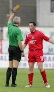 26 August 2006; The former Donegal GAA star Brendan Devenney who recently signed with Portadown receives a yellow card from referee Brian Turkington. CIS Insurance Cup, Portadown v Crusaders, Shamrock Park, Portadown, Co. Armagh. Picture credit: Oliver McVeigh / SPORTSFILE