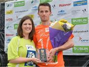 20 July 2014; Paddy Hamilton, is presented with his trophy after winning the Men's  Fingal 10K - SSE Airtricity Dublin Race Series 2014, by Jillian Saunders, SSE Airtricity. Fingal 10K - SSE Airtricity Dublin Race Series 2014. Swords, Co. Dublin. Picture credit: David Maher / SPORTSFILE