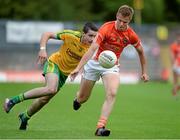 20 July 2014; Oisin O'Neill, Armagh, in action against Caolan McGonigle, Donegal. Electric Ireland Ulster GAA Football Minor Championship Final, Armagh v Donegal, St Tiernach's Park, Clones, Co. Monaghan. Picture credit: Oliver McVeigh / SPORTSFILE