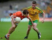 20 July 2014; Ryan Hughes, Armagh, in action against Danny McMonigle, Donegal. Electric Ireland Ulster GAA Football Minor Championship Final, Armagh v Donegal, St Tiernach's Park, Clones, Co. Monaghan. Picture credit: Oliver McVeigh / SPORTSFILE