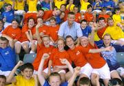 24 August 2006; Dublin football Manager Paul Caffrey with young children from the Docklands who he presented with certificates for participating in the Docklands Festival of Hurling and Gaelic Football. Parnell Park, Dublin. Picture credit; Brian Lawless / SPORTSFILE