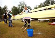 26 August 2006; Ireland rowing managment team of Mick O'Callaghan, right, team manager, Debbie Fox, assistant coach, and Harald Jahrling, head coach, wash down a boat, in preparation for tomorrow's Lightweight men's four's final, of Paul Griffin, Richard Archibald, Eugene Coakley and Gearoid Towey,  at the 2006 World Rowing Championships. Dorney Lake, Eton, England. Picture credit; David Maher / SPORTSFILE