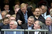 27 August 2006; Leader of the opposition Enda Kenny, T.D., leans forward to wish An Taoiseach Bertie Ahern T.D. well before the start of the game, watched by President of the GAA Nickey Brennan and former President of the GAA Sean McCague. Tommy Murphy Cup Final, Louth v Leitrim, Croke Park, Dublin. Picture credit; Brian Lawless / SPORTSFILE