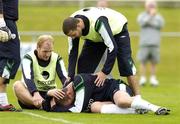 30 August 2006; John O'Shea checks on the condition of team-mate Richard Dunne after a clash of heads with Gary Doherty, left, during Republic of Ireland squad training. Malahide FC, Malahide, Dublin. Picture credit: Pat Murphy / SPORTSFILE
