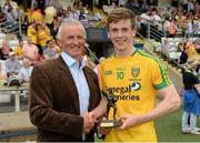 20 July 2014; Vincent Litchfield, from Electric Ireland, proud sponsor of the GAA All-Ireland Minor Championships, presents Eoghan Ban Gallagher, from Donegal with the player of the match award for his outstanding performance in the Ulster GAA Football Minor Championship Final. Electric Ireland Ulster GAA Football Minor Championship Final, Armagh v Donegal, St Tiernach's Park, Clones, Co. Monaghan. Picture credit: Oliver McVeigh / SPORTSFILE