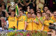 20 July 2014; Donegal captain Niall Harley lifts the Fr Murray cup as his team-mates celebrate. Electric Ireland Ulster GAA Football Minor Championship Final, Armagh v Donegal, St Tiernach's Park, Clones, Co. Monaghan. Picture credit: Oliver McVeigh / SPORTSFILE
