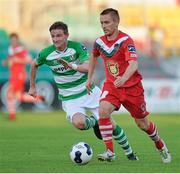 21 July 2014; Liam Kearney, Cork City, in action against Ronan Finn, Shamrock Rovers. EA Sports Cup, Quarter-Final, Shamrock Rovers v Cork City, Tallaght Stadium, Tallaght, Co. Dublin. Picture credit: David Maher / SPORTSFILE