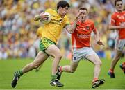 20 July 2014; Stephen McBrearty, Donegal, in action against Cathal Donnelly, Armagh. Electric Ireland Ulster GAA Football Minor Championship Final, Armagh v Donegal, St Tiernach's Park, Clones, Co. Monaghan. Picture credit: Oliver McVeigh / SPORTSFILE