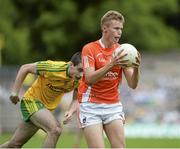 20 July 2014; Oisin O'Neill, Armagh, in action against Caolan McGonigle, Donegal. Electric Ireland Ulster GAA Football Minor Championship Final, Armagh v Donegal, St Tiernach's Park, Clones, Co. Monaghan. Picture credit: Oliver McVeigh / SPORTSFILE