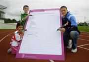 30 August 2006; Dublin GAA star Conal Keaney lends a helping hand to youngsters Aaron Ashmore, age 8, and Amy Hadad, age 7, as they complete the first nomination for Ireland's first ever 'National Awards to Volunteers in Irish Sport'. Minister O'Donoghue called on sports clubs throughout the country to nominate volunteers for the new awards which will recognise the role that the country's 400,000 volunteers play in sustaining and developing sport in Ireland. Irishtown Stadium, Ringsend, Dublin. Picture credit; Brendan Moran / SPORTSFILE