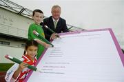 30 August 2006; Minister for Arts, Sport and Tourism, John O'Donoghue, TD, lends a helping hand to youngsters Aaron Ashmore, age 8, and Amy Hadad, age 7, as they complete the first nomination for Ireland's first ever 'National Awards to Volunteers in Irish Sport'. Minister O'Donoghue called on sports clubs throughout the country to nominate volunteers for the new awards which will recognise the role that the country's 400,000 volunteers play in sustaining and developing sport in Ireland. Irishtown Stadium, Ringsend, Dublin. Picture credit; Brendan Moran / SPORTSFILE