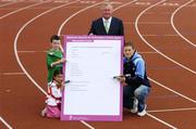 30 August 2006; Minister for Arts, Sport and Tourism, John O'Donoghue, TD, and Dublin GAA star Conal Keaney lend a helping hand to youngsters Aaron Ashmore, age 8, and Amy Hadad, age 7, as they complete the first nomination for Ireland's first ever 'National Awards to Volunteers in Irish Sport'. Minister O'Donoghue called on sports clubs throughout the country to nominate volunteers for the new awards which will recognise the role that the country's 400,000 volunteers play in sustaining and developing sport in Ireland. Irishtown Stadium, Ringsend, Dublin. Picture credit; Brendan Moran / SPORTSFILE